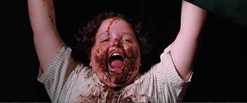 Movie still from “Matilda” (1996), directed by Danny DeVito – A young child with a messy face covered in chocolate; Close Up shot, Overhead angle