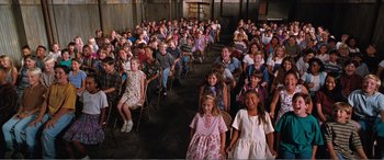 Movie still from “Matilda” (1996), directed by Danny DeVito – A large group of children sitting in a room; Wide shot, High angle