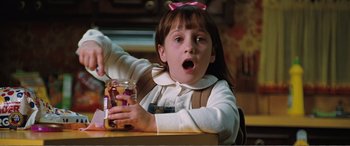 Movie still from “Matilda” (1996), directed by Danny DeVito – A little girl is holding a jar of food; Close Up shot, High angle