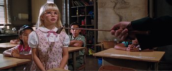 Movie still from “Matilda” (1996), directed by Danny DeVito – A girl and a boy are in a class room; Medium shot, Over the shoulder angle