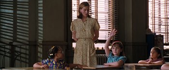 Movie still from “Matilda” (1996), directed by Danny DeVito – A woman standing in front of two young children; Medium shot, Over the shoulder angle