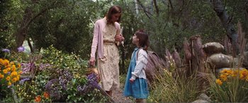 Movie still from “Matilda” (1996), directed by Danny DeVito – A woman and a girl are walking in the woods; Medium shot, Over the shoulder angle