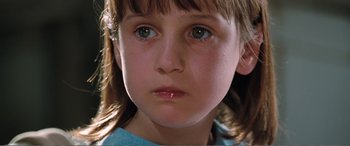Movie still from “Matilda” (1996), directed by Danny DeVito – A young girl's face with blue eyes; Close Up shot, Low angle
