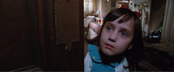Movie still from “Matilda” (1996), directed by Danny DeVito – A little girl is looking into the camera; Close Up shot, High angle