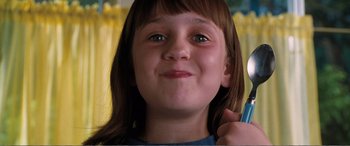 Movie still from “Matilda” (1996), directed by Danny DeVito – A young girl holding a cell phone up to her ear; Close Up shot, Low angle