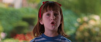 Movie still from “Matilda” (1996), directed by Danny DeVito – A little girl with a red bow in her hair; Close Up shot, High angle