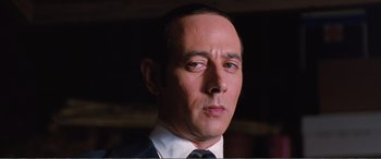 Movie still from “Matilda” (1996), directed by Danny DeVito – A person wearing a suit and tie; Close Up shot, Low angle