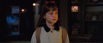 Movie still from “Matilda” (1996), directed by Danny DeVito – A young girl wearing a red bow in her hair; Close Up shot, High angle