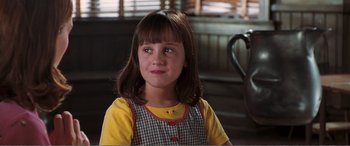 Movie still from “Matilda” (1996), directed by Danny DeVito – A little girl sitting in front of a window; Close Up shot, Over the shoulder angle