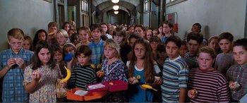Movie still from “Matilda” (1996), directed by Danny DeVito – A large group of children standing in a hallway; Wide shot, High angle