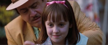 Movie still from “Matilda” (1996), directed by Danny DeVito – A little girl with a pink bow in her hair; Close Up shot, Over the shoulder angle