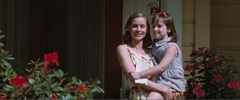 Movie still from “Matilda” (1996), directed by Danny DeVito – A woman and a girl posing for a picture; Medium shot, Low angle