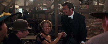 Movie still from “Maverick” (1994), directed by Richard Donner – A man and a woman shaking hands in front of a building; Medium shot, Over the shoulder angle