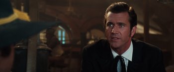 Movie still from “Maverick” (1994), directed by Richard Donner – A person wearing a suit and tie; Close Up shot, Over the shoulder angle