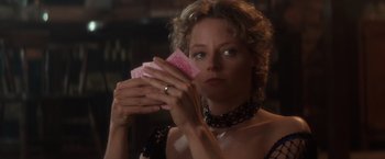 Movie still from “Maverick” (1994), directed by Richard Donner – A woman holding a deck of playing cards in her hands; Close Up shot, Over the shoulder angle