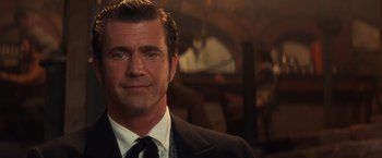 Movie still from “Maverick” (1994), directed by Richard Donner – A man wearing a suit and tie in front of a mirror; Close Up shot, Over the shoulder angle