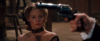 Movie still from “Maverick” (1994), directed by Richard Donner – A woman in a black dress is looking into a mirror; Close Up shot, Over the shoulder angle