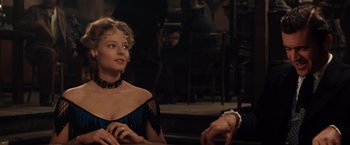 Movie still from “Maverick” (1994), directed by Richard Donner – A woman in a black dress sitting next to a man; Close Up shot, Over the shoulder angle