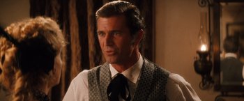 Movie still from “Maverick” (1994), directed by Richard Donner – A man wearing a vest and a tie; Close Up shot, Over the shoulder angle