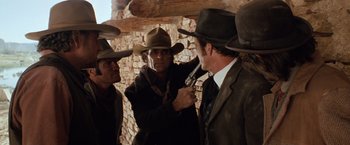 Movie still from “Maverick” (1994), directed by Richard Donner – A group of men standing next to each other; Medium shot, Over the shoulder angle