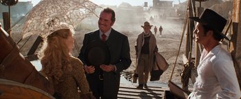 Movie still from “Maverick” (1994), directed by Richard Donner – A group of people walking down a street; Wide shot, Over the shoulder angle