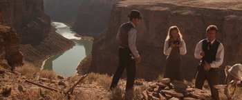 Movie still from “Maverick” (1994), directed by Richard Donner – A man and a woman standing on top of a mountain; Wide shot, Over the shoulder angle