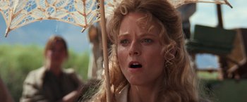 Movie still from “Maverick” (1994), directed by Richard Donner – A person holding an open umbrella; Close Up shot, Low angle