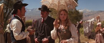 Movie still from “Maverick” (1994), directed by Richard Donner – A man and a woman holding an open umbrella; Medium shot, Low angle