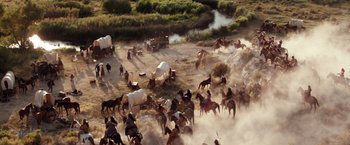 Movie still from “Maverick” (1994), directed by Richard Donner – A herd of horses running through a field; Extreme Wide shot, High angle