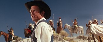 Movie still from “Maverick” (1994), directed by Richard Donner – A man wearing a cowboy hat standing on a hill; Medium shot, Low angle