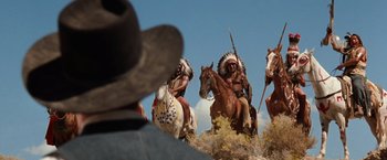 Movie still from “Maverick” (1994), directed by Richard Donner – A group of native americans on horses in the desert; Wide shot, Low angle