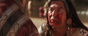 Movie still from “Maverick” (1994), directed by Richard Donner – A man with face paint is looking at another man; Close Up shot, Over the shoulder angle