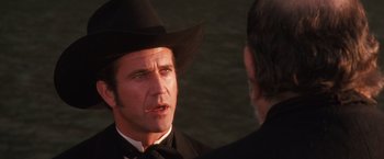 Movie still from “Maverick” (1994), directed by Richard Donner – A man wearing a cowboy hat talking to another man; Close Up shot, Over the shoulder angle
