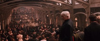 Movie still from “Maverick” (1994), directed by Richard Donner – An old man is standing in front of a group of people; Wide shot, High angle
