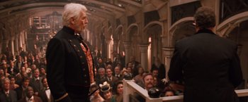 Movie still from “Maverick” (1994), directed by Richard Donner – An old man standing in front of a crowd of people; Wide shot, Low angle