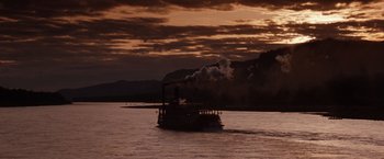 Movie still from “Maverick” (1994), directed by Richard Donner – A steam boat on a body of water at sunset; Extreme Wide shot, Low angle