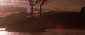 Movie still from “Maverick” (1994), directed by Richard Donner – A ship with smoke coming out of the stacks; Extreme Wide shot, Low angle