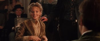 Movie still from “Maverick” (1994), directed by Richard Donner – A woman sitting in front of another woman; Medium shot, Over the shoulder angle