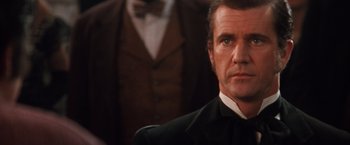 Movie still from “Maverick” (1994), directed by Richard Donner – A man in a suit and a tie; Close Up shot, Over the shoulder angle