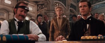 Movie still from “Maverick” (1994), directed by Richard Donner – A woman standing in front of a group of people; Medium shot, Low angle