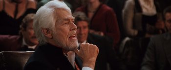 Movie still from “Maverick” (1994), directed by Richard Donner – An older man with white hair and a white beard; Close Up shot, Over the shoulder angle