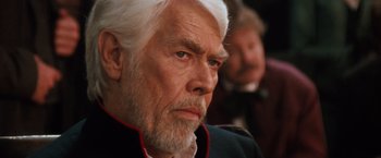 Movie still from “Maverick” (1994), directed by Richard Donner – An older man with white hair and wearing a black jacket; Close Up shot, Over the shoulder angle