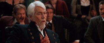 Movie still from “Maverick” (1994), directed by Richard Donner – An older man with white hair wearing a black jacket; Close Up shot, Over the shoulder angle