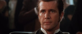 Movie still from “Maverick” (1994), directed by Richard Donner – A man that is wearing a suit and tie; Close Up shot, Over the shoulder angle