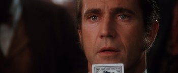 Movie still from “Maverick” (1994), directed by Richard Donner – A person holding a deck of playing cards; Close Up shot, Over the shoulder angle