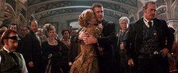 Movie still from “Maverick” (1994), directed by Richard Donner – A man and a woman hugging in a crowd; Medium shot, Low angle