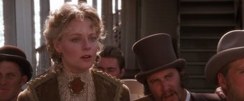 Movie still from “Maverick” (1994), directed by Richard Donner – A man and a woman in top hats and coats; Close Up shot, Over the shoulder angle