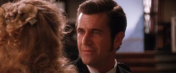 Movie still from “Maverick” (1994), directed by Richard Donner – A person wearing a suit and tie; Close Up shot, Over the shoulder angle