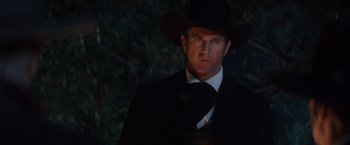 Movie still from “Maverick” (1994), directed by Richard Donner – A man in a black suit and a black cowboy hat; Close Up shot, Low angle