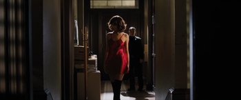 Movie still from “Max Payne” (2008), directed by John Moore – A woman in a short red dress walking down a hall way; Wide shot, Over the shoulder angle